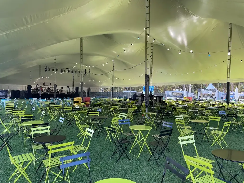 A festival crowd under a long Somersault structure