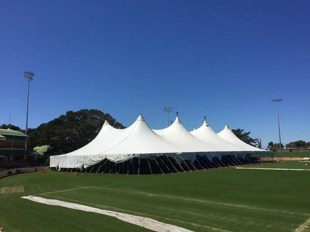 A Regal event tent built across a sports oval under clear sky